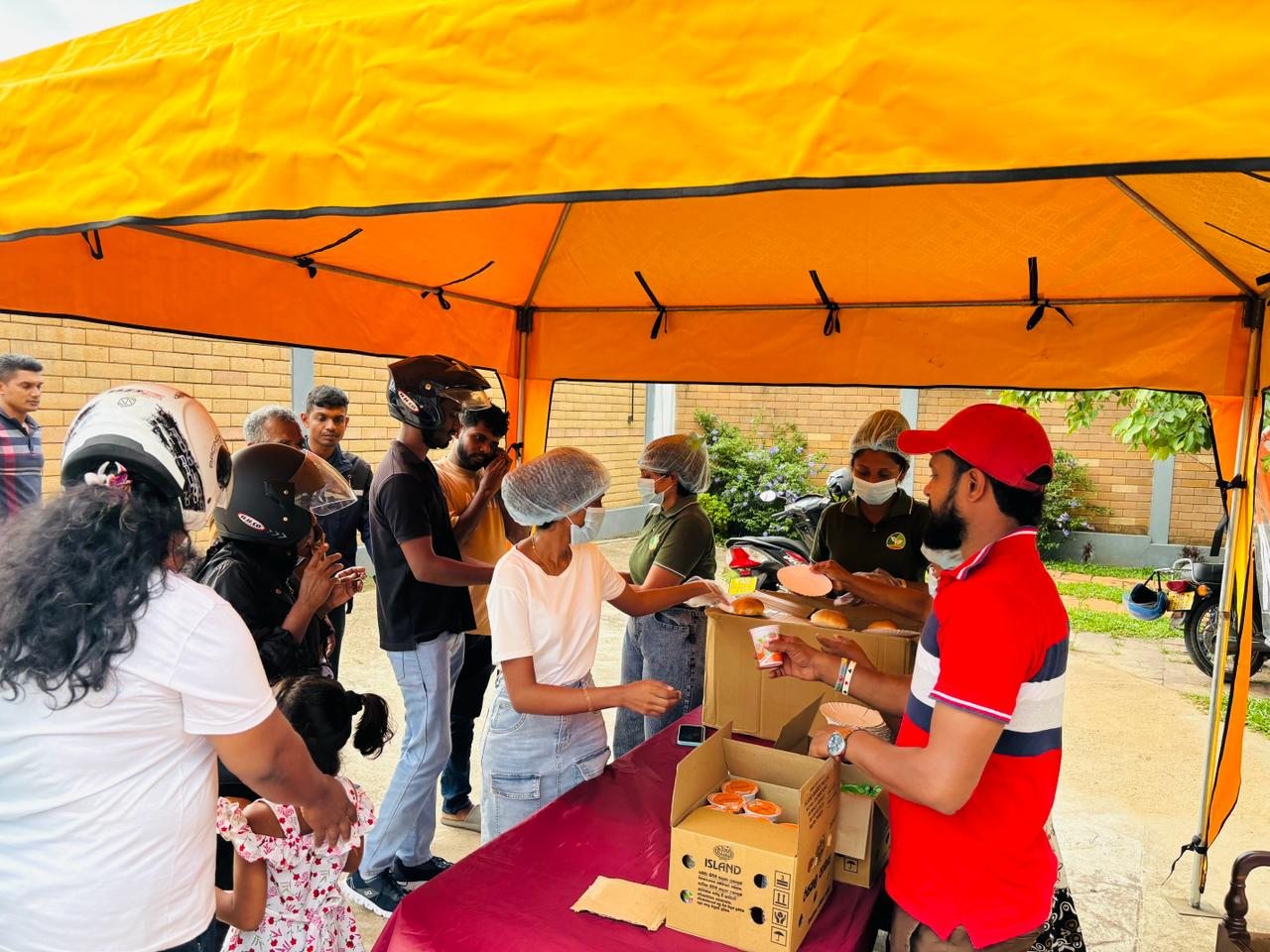 Supreme Agro team serving food at a community event